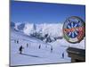 Sign with Skiers and Mountains in the Background at the Ski Resort of Livigno in Northern Italy-Teegan Tom-Mounted Photographic Print