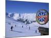 Sign with Skiers and Mountains in the Background at the Ski Resort of Livigno in Northern Italy-Teegan Tom-Mounted Photographic Print