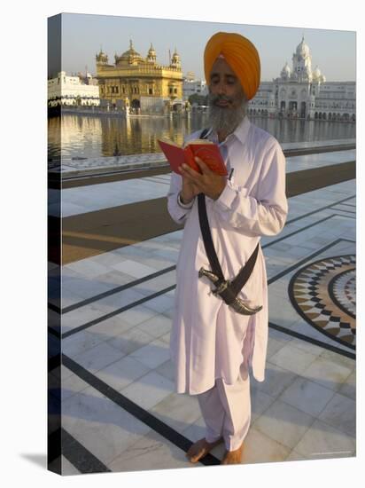 Sikh Pilgrim with Orange Turban, White Dress and Dagger, Reading Prayer Book, Amritsar-Eitan Simanor-Stretched Canvas