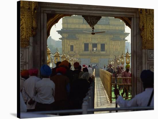 Sikhs at the Entrance to the Golden Temple, Crossing Guru's Bridge, Amritsar, Punjab, India-Jeremy Bright-Stretched Canvas