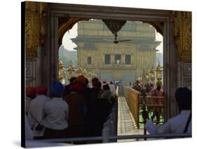 Sikhs at the Entrance to the Golden Temple, Crossing Guru's Bridge, Amritsar, Punjab, India-Jeremy Bright-Stretched Canvas