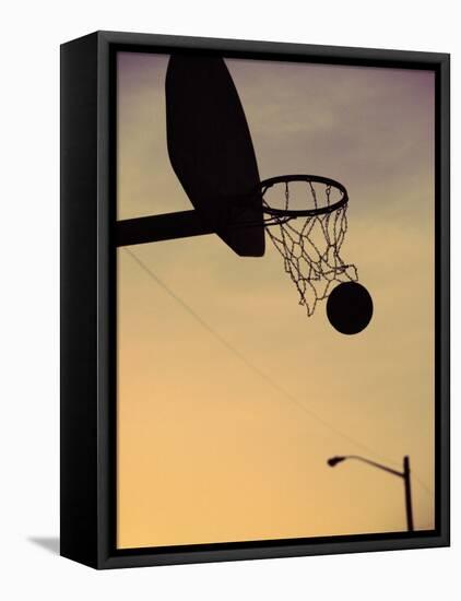 Silhouette of a Basketball Going Through a Basketball Net-null-Framed Stretched Canvas