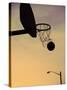 Silhouette of a Basketball Going Through a Basketball Net-null-Stretched Canvas