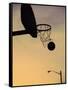 Silhouette of a Basketball Going Through a Basketball Net-null-Framed Stretched Canvas