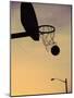 Silhouette of a Basketball Going Through a Basketball Net-null-Mounted Premium Photographic Print