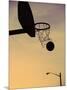 Silhouette of a Basketball Going Through a Basketball Net-null-Mounted Photographic Print