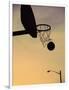 Silhouette of a Basketball Going Through a Basketball Net-null-Framed Photographic Print