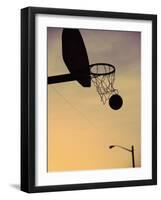 Silhouette of a Basketball Going Through a Basketball Net-null-Framed Photographic Print