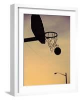 Silhouette of a Basketball Going Through a Basketball Net-null-Framed Photographic Print