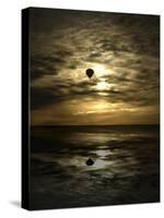 Silhouette of a Hot Air Balloon Over Water-null-Stretched Canvas