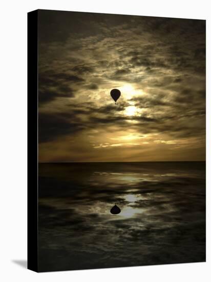 Silhouette of a Hot Air Balloon Over Water-null-Stretched Canvas