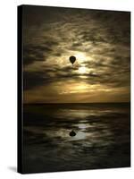 Silhouette of a Hot Air Balloon Over Water-null-Stretched Canvas