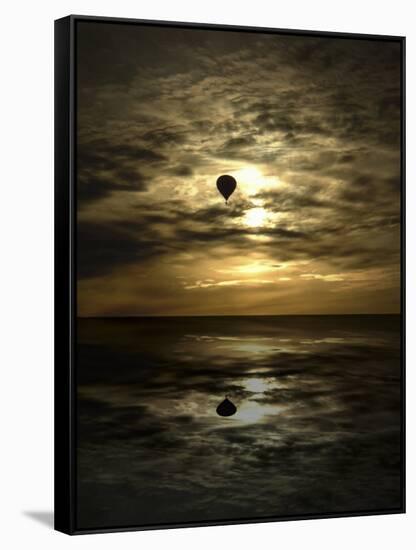 Silhouette of a Hot Air Balloon Over Water-null-Framed Stretched Canvas