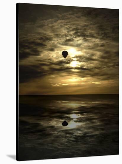 Silhouette of a Hot Air Balloon Over Water-null-Stretched Canvas