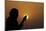 Silhouette of a Muslim woman holding prayer beads in her hands and praying at sunset-Godong-Mounted Photographic Print