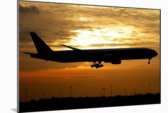 Silhouette of a Pakistan International Airlines Boeing 777-null-Mounted Photographic Print