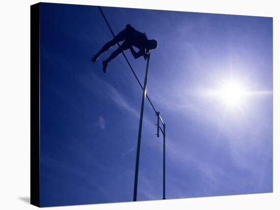 Silhouette of a Pole Vaulter in Action-null-Stretched Canvas