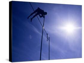 Silhouette of a Pole Vaulter in Action-null-Stretched Canvas