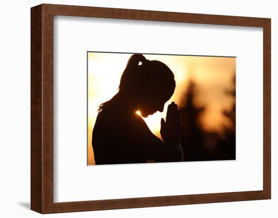 Silhouette of a woman practising yoga against the light of the evening sun, French Alps, France-Godong-Framed Photographic Print