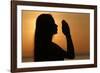 Silhouette of a woman standing by the sea at sunset doing yoga pose and meditation, Kep, Cambodia-Godong-Framed Photographic Print