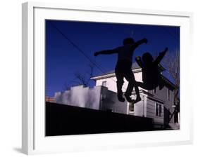 Silhouette of Children Bouncing on a Trampoline-Bill Eppridge-Framed Photographic Print