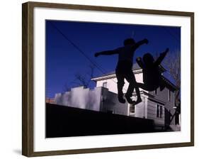 Silhouette of Children Bouncing on a Trampoline-Bill Eppridge-Framed Photographic Print