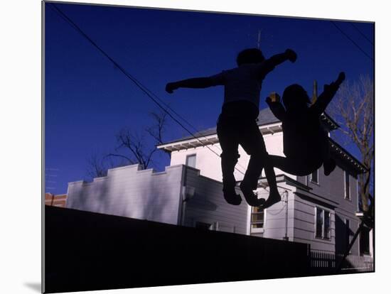 Silhouette of Children Bouncing on a Trampoline-Bill Eppridge-Mounted Photographic Print