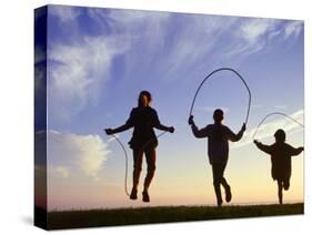 Silhouette of Children Jumping Rope Outdoors-Mitch Diamond-Stretched Canvas