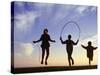 Silhouette of Children Jumping Rope Outdoors-Mitch Diamond-Stretched Canvas