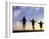 Silhouette of Children Jumping Rope Outdoors-Mitch Diamond-Framed Photographic Print