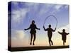 Silhouette of Children Jumping Rope Outdoors-Mitch Diamond-Stretched Canvas