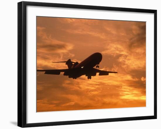 Silhouette of Commercial Airplane at Sunset-Mitch Diamond-Framed Photographic Print