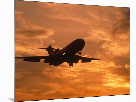 Silhouette of Commercial Airplane at Sunset-Mitch Diamond-Mounted Photographic Print