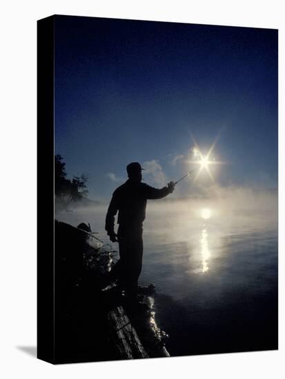 Silhouette of Fisherman Casting a Line into Lake, Ontario, Canada-Mark Carlson-Stretched Canvas