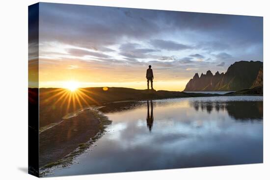 Silhouette of man standing on rocks watching the mountain peaks at sunset, Tungeneset viewpoint-Roberto Moiola-Stretched Canvas