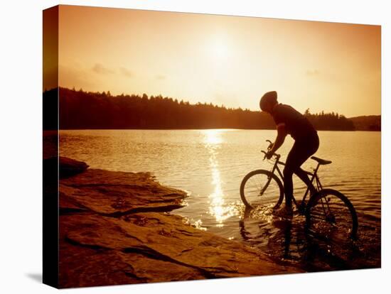 Silhouette of Mountain Biker at Sunset-null-Stretched Canvas