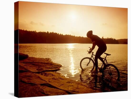 Silhouette of Mountain Biker at Sunset-null-Stretched Canvas