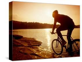 Silhouette of Mountain Biker at Sunset-null-Stretched Canvas