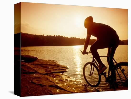 Silhouette of Mountain Biker at Sunset-null-Stretched Canvas