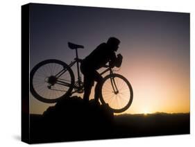 Silhouette of Mountain Biker at the Summit During Sunrise-null-Stretched Canvas