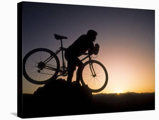 Silhouette of Mountain Biker at the Summit During Sunrise-null-Stretched Canvas