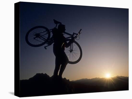 Silhouette of Mountain Biker at the Summit During Sunrise-null-Stretched Canvas