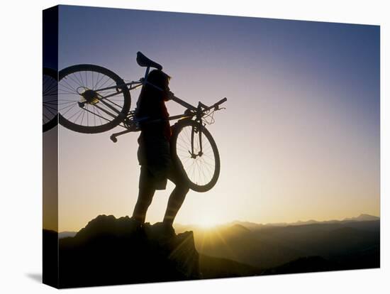 Silhouette of Mountain Biker at the Summit During Sunrise-null-Stretched Canvas