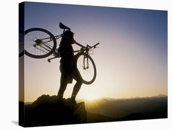 Silhouette of Mountain Biker at the Summit During Sunrise-null-Stretched Canvas