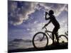 Silhouette of Mountain Biker Drinking at the Summit During Sunset-null-Mounted Photographic Print
