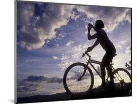 Silhouette of Mountain Biker Drinking at the Summit During Sunset-null-Mounted Photographic Print