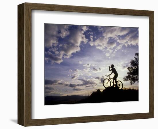 Silhouette of Mountain Biker Drinking at the Summit During Sunset-null-Framed Photographic Print