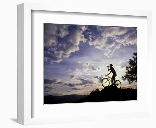 Silhouette of Mountain Biker Drinking at the Summit During Sunset-null-Framed Photographic Print