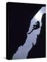 Silhouette of Rock Climber Hanging from Cliff Face-null-Stretched Canvas