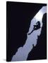 Silhouette of Rock Climber Hanging from Cliff Face-null-Stretched Canvas